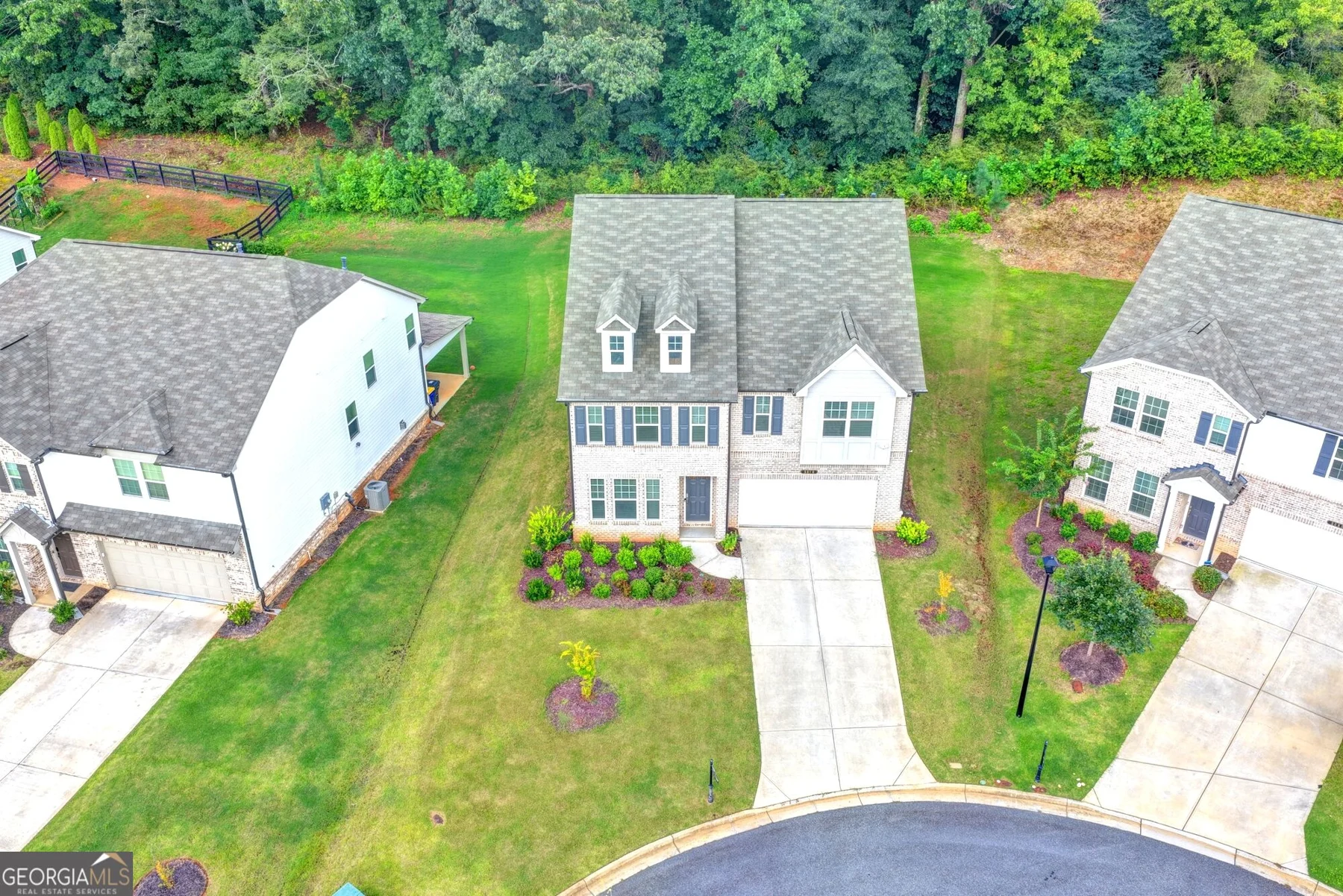Aerial view of the home and surrounding properties