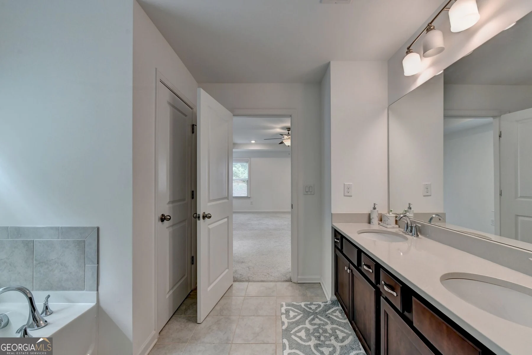Bathroom with double vanity and separate shower