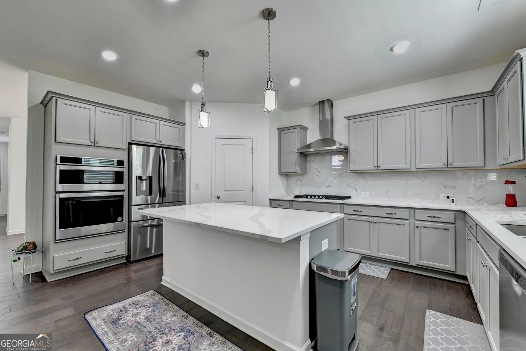 Kitchen with light cabinetry, island and stainless-steel appliances