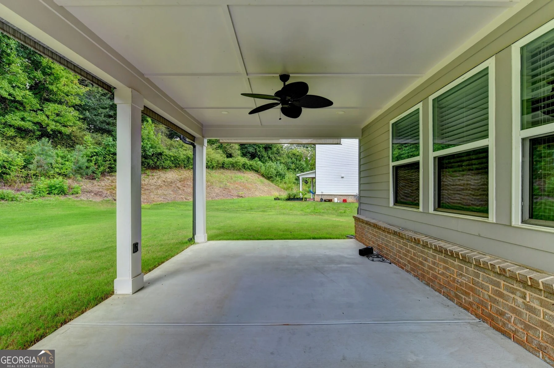 Covered rear patio overlooking the lawn
